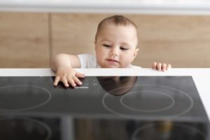 Toddler touching cooktop